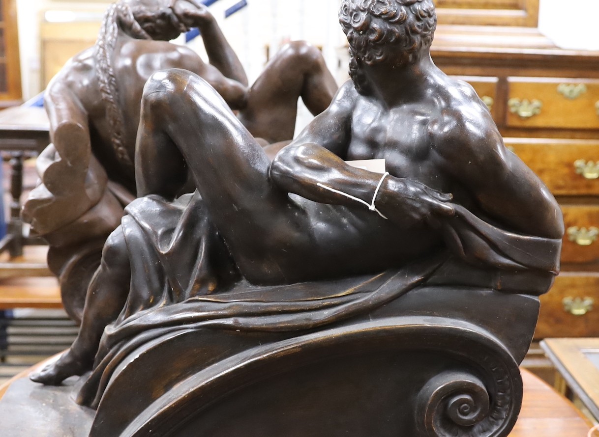 A pair of large classical composition reclining figures, 57 cm high